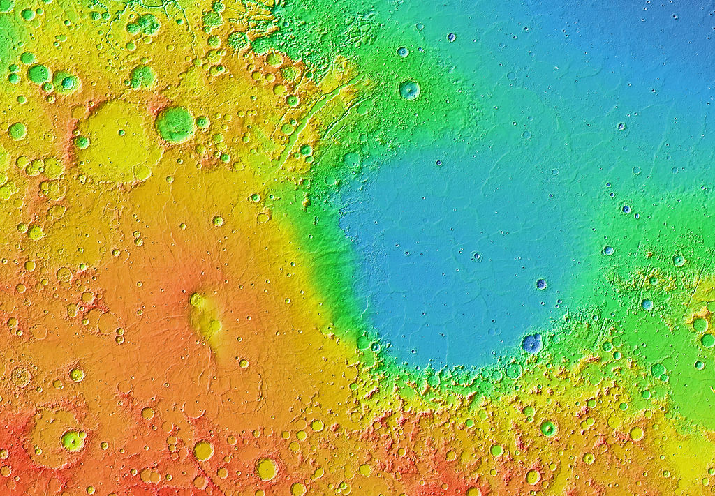 Mars Orbiter Laser Altimeter (MOLA) colorised topographic map showing height by color with Isidis Planitia visible in blue in the center-right of the image. Image credit: Courtesy NASA / JPL-Caltech / Arizona State University